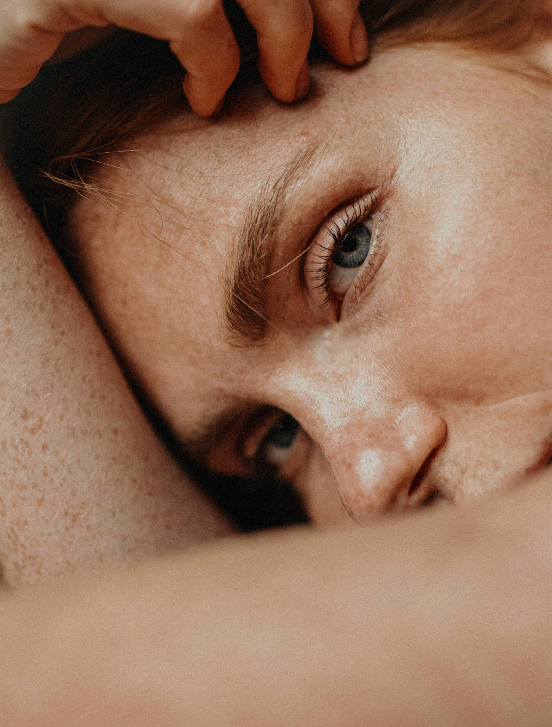 model with hand on her face